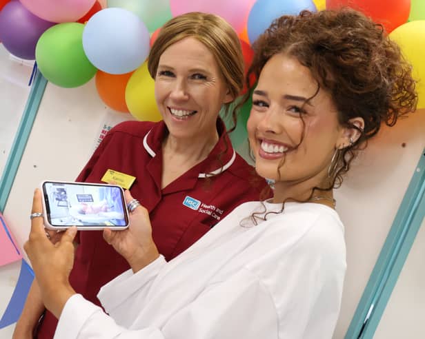 Jude Davis, a newly qualified midwife, shows Katrina McCullough, clinical skills midwife, a photograph taken when she was born in the Midwifery Led Unit at Craigavon Area Hospital 21 years ago this month.