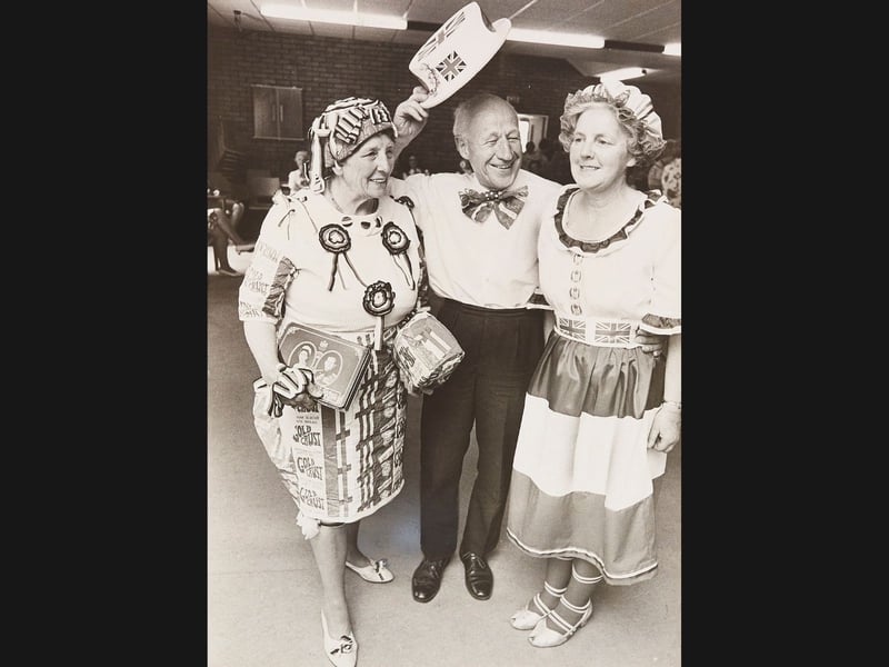 A winning trio! On June 10, 1977, prizewinners Mrs Irene Mason, Mr Jack Large, and Mrs Ella Hawthorne strike a joyful pose following a Jubilee fancy dress parade at the Roseville Centre in Coseley. From Union Jack hats and patriotic bow ties to creative home-spun outfits adorned with bread wrappers and royal tins, the festive trio showed off the absolute best of local party spirit during Queen Elizabeth II's Silver Jubilee celebrations.