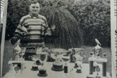  Mr Edmund Taylor from Richhill with two of his winning canaries, along with several cups and trophies his birds have won.