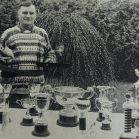  Mr Edmund Taylor from Richhill with two of his winning canaries, along with several cups and trophies his birds have won.