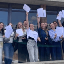 Students celebrating outside the school