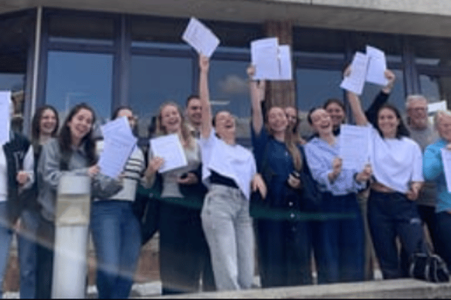 Students celebrating outside the school