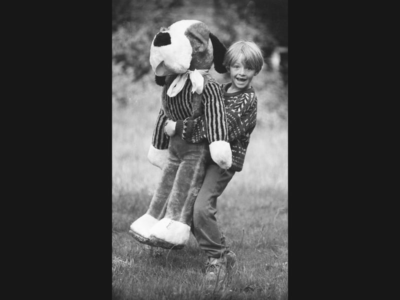 Talk about carrying your weight! Eight-year-old Daniel Perry of Horsley Heath grins widely as he lugs around a giant cuddly dog during a Saturday morning table sale at Centenary Methodist Chapel in Tipton. Organised by Sunday school helpers in June 1993, the weekly outdoor sales brought the local community together for much-needed fundraising, with young helpers doing their bit to support the beloved place of worship.