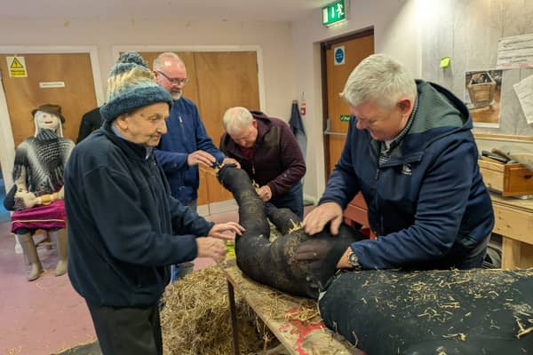 Scarecrow makers from Park Men's Shed hard at work.