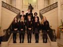 Marcas, Raimondas, Riquelme, Vyte, Alex, Amy, Caitlin and Grace are pictured on the stairs of Parliament Buildings during their visit to Stormont.