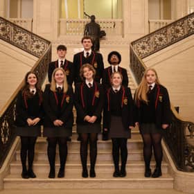 Marcas, Raimondas, Riquelme, Vyte, Alex, Amy, Caitlin and Grace are pictured on the stairs of Parliament Buildings during their visit to Stormont.