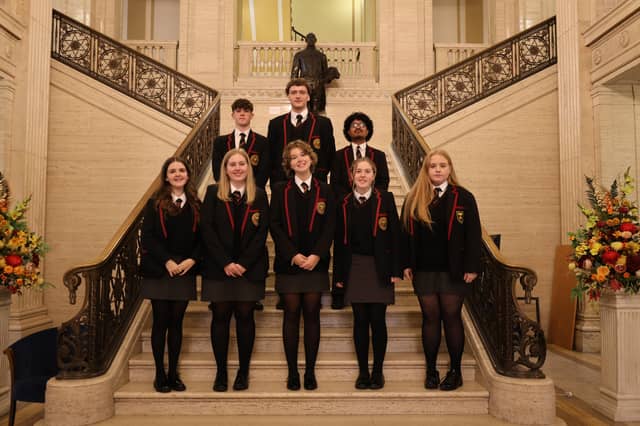 Marcas, Raimondas, Riquelme, Vyte, Alex, Amy, Caitlin and Grace are pictured on the stairs of Parliament Buildings during their visit to Stormont.