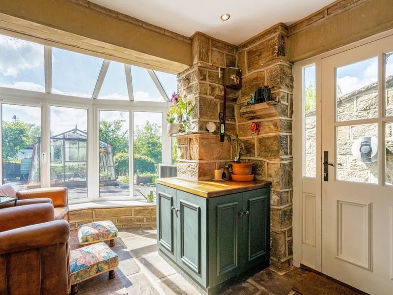 A small conservatory creates a lovely transition from the house to the garden.