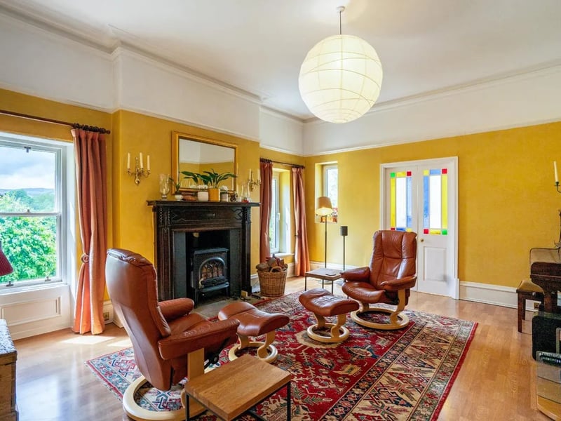 The latter of the living rooms, filled with light and also featuring a wood burner for those winter months.