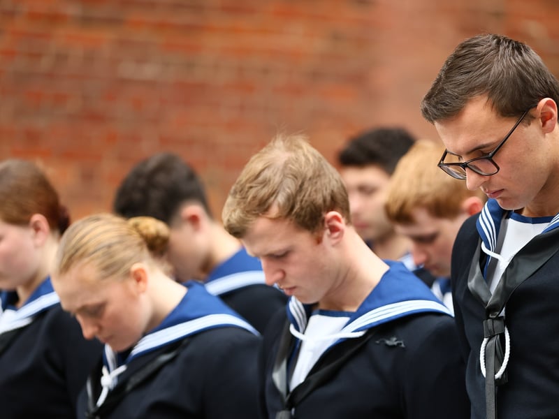 Sailors from HMS Collingwood bow their heads during a prayer written by Admiral Nelson.