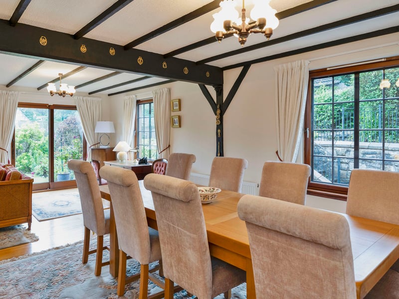 Furthermore, the neutral palette enhances the airy ambience, as the wooden floor and exposed ceiling beams add a traditional touch to the elegant aesthetic. A stone-style surround inset with an electric stove provides the finishing touch.