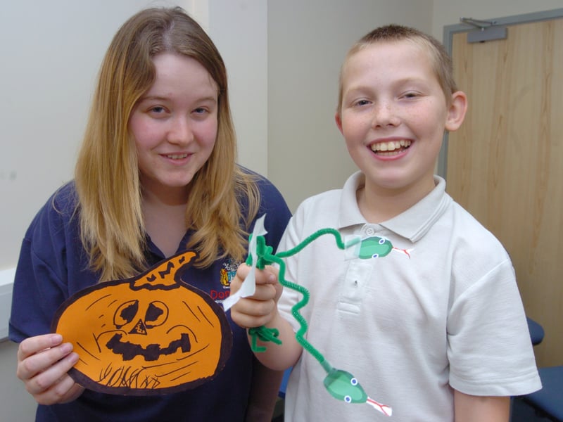 Library Assistant Hollie Morrell helps Thomas Payling, ten, of Denaby, make Halloween decorations at Denaby Springwell Centre.