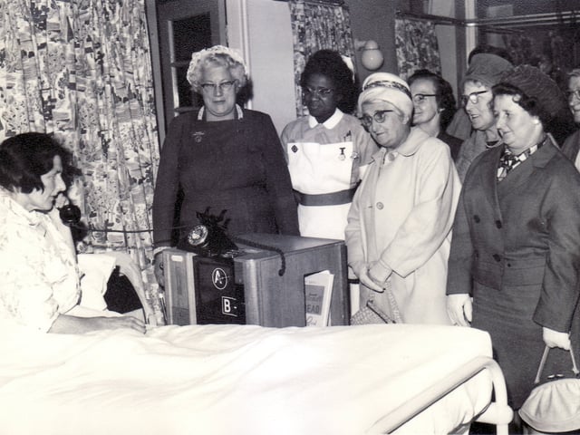 Mrs Winifred Hart, a patient for six weeks, is the first to use the telephone trolley presented to Lodge Moor Hospital, Sheffield, by Stannington Community Association.  The matron, Miss A Holder, and association members look on as Mrs Hartley calls her 10 year old grandaughter, Denise Bennett of Sharrard Road, Intake.Sheffield Newspapers pictured submitted by Bill Ronksley