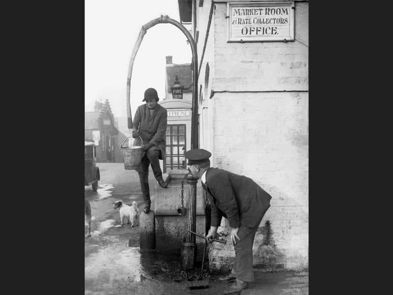 A resident getting water from a standpipe in Alton, Hampshire, 1934