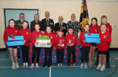 Pupils at Gortin Primary School helped Newtownstewart Royal British Legion branch launch their Poppy Appeal 2026. Pictured are members of the student council, Mia Baxter, Grace Scott, Sophia Lucas, Ellie Warnock, Ross Warnock, James Orr, Scarlet Black, Lottie Armstrong, Epsie Alison and Harvey Wauchob, with Derek Hussey and branch officers Hazel Ross, secretary, James Baxter, president and Lord Lieutenant for County Tyrone, Allen Scott, chairman and Victoria Ross, vice-chairman. AN441526  