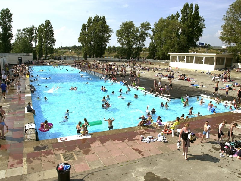 The crowds enjoy both the weather and the warm water at Hilsea Lido in August 2002. 
Picture: Malcolm Wells (024203-30)