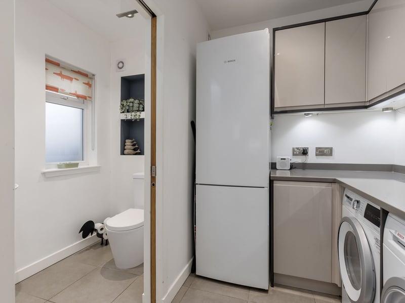 There is also this spacious utility room providing excellent storage and appliance space, WC and a substantial eaves storage area.