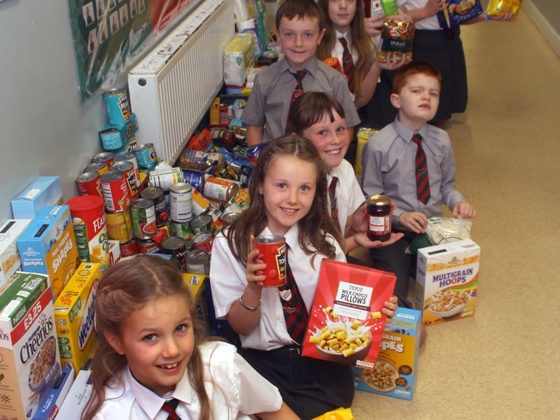 Lisnadill Primary School children with their collection of food items they brought to Harvest to donate to the Armagh Foodbank.