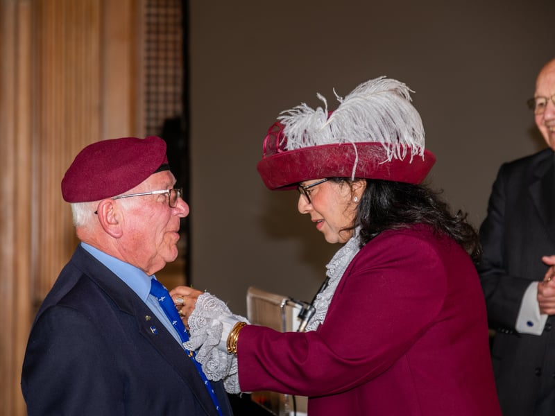 Veteran Paul Bradford receiving his poppy from Dr Ruby Bhatti OBE DL High Sheriff of West Yorkshire