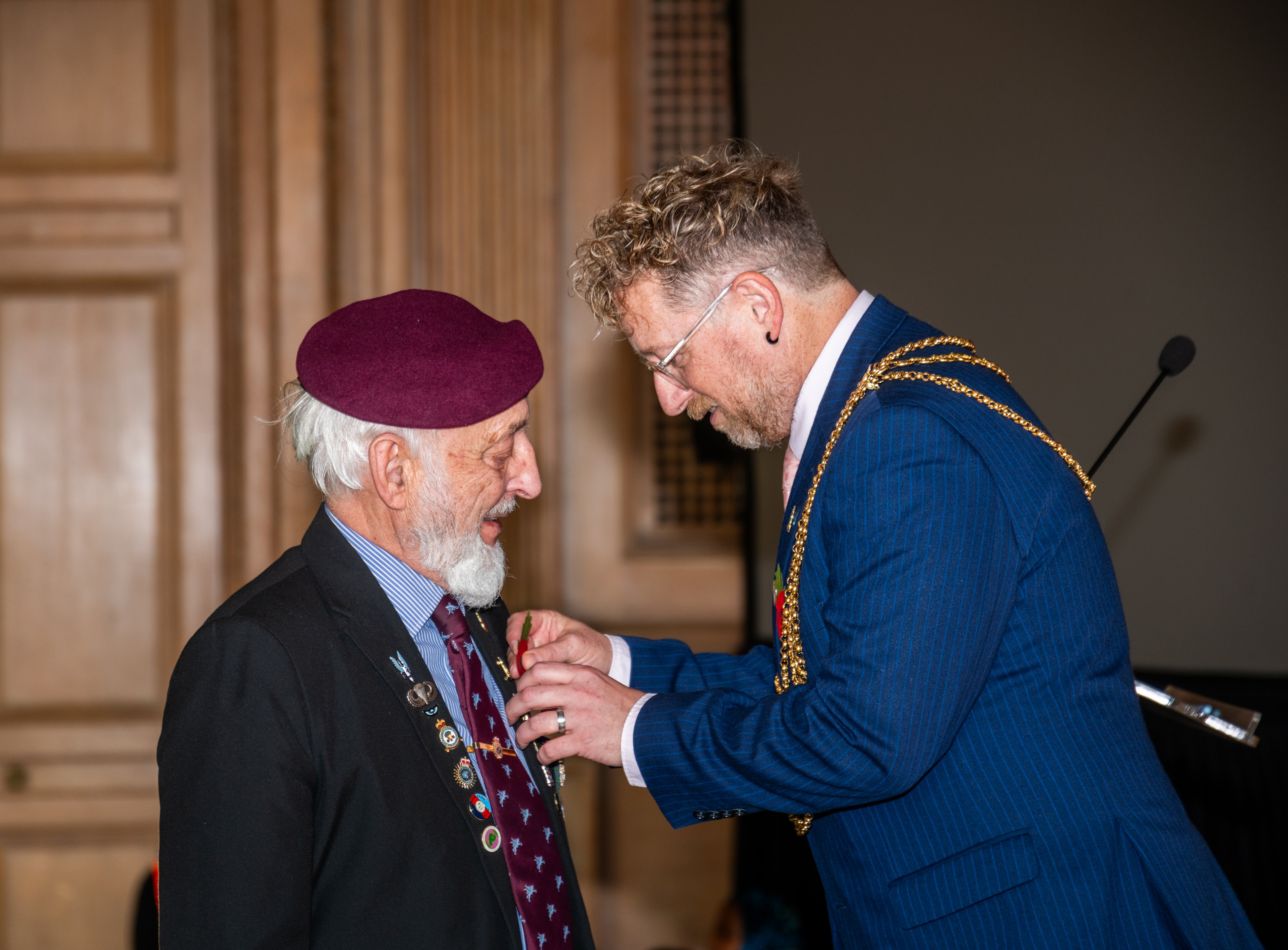  Veteran Neil Munro receiving his poppy from the Lord Mayor of Leeds Stephen Holroyd.