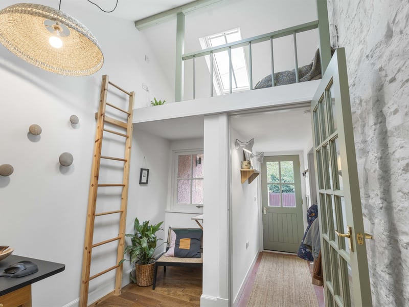 A mezzanine level provides a versatile spot for guests or a peaceful reading nook.