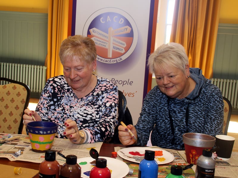Ladies enjoying the calming creative session of decorating a terracotta pot and planting bulbs.