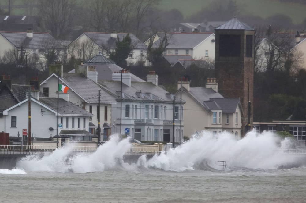 Waves break against the sea wall in Carnlough on the north east coast of Northern Ireland early in the morning of January 24, 2025, as storm Eowyn brings winds of 100 mph to the UK and Ireland.