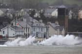 Waves break against the sea wall in Carnlough on the north east coast of Northern Ireland early in the morning of January 24, 2025, as storm Eowyn brings winds of 100 mph to the UK and Ireland.