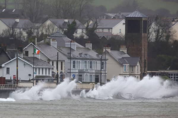 Waves break against the sea wall in Carnlough on the north east coast of Northern Ireland early in the morning of January 24, 2025, as storm Eowyn brings winds of 100 mph to the UK and Ireland.