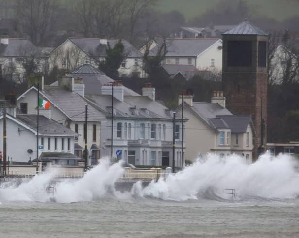 Waves break against the sea wall in Carnlough on the north east coast of Northern Ireland early in the morning of January 24, 2025, as storm Eowyn brings winds of 100 mph to the UK and Ireland.