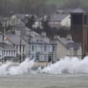 Waves break against the sea wall in Carnlough on the north east coast of Northern Ireland early in the morning of January 24, 2025, as storm Eowyn brings winds of 100 mph to the UK and Ireland.