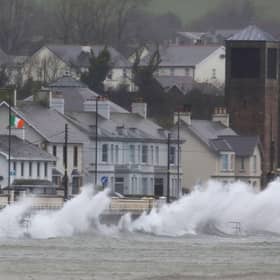 Waves break against the sea wall in Carnlough on the north east coast of Northern Ireland early in the morning of January 24, 2025, as storm Eowyn brings winds of 100 mph to the UK and Ireland.