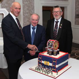 Band master of 50 years and founder member, Kenny Porter, left, with fellow founding members, Norman Crawford and Ivan McDonald get ready to cut the cake to mark the Omagh Protestant Boys Flute Band 50th anniversary. The beautiful anniversary cake was made by band members, Stacey Connor and Sarah Beckett.  IB1844CD26
