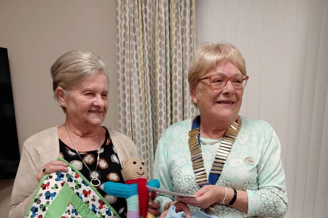 President Kathleen thanks Mrs Betty Fiddes from Project Linus (UK) who is displaying some of the quilts.