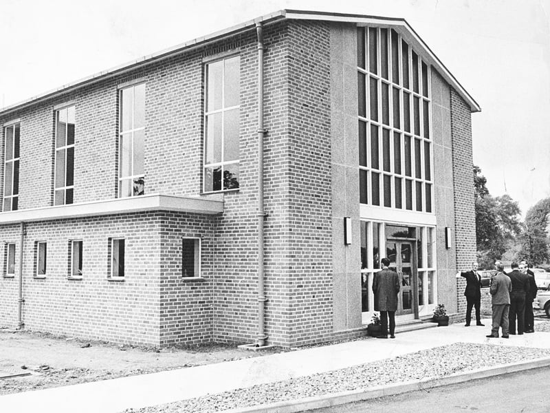 A group gathers outside the striking modern entrance of the newly opened Presbyterian Church of England in Castlecroft, Wolverhampton, on May 21, 1966. Featuring tall glass window panes and fresh brickwork, the contemporary structure marked a proud new chapter for the local worship community. Do you remember when this new church opened its doors in Castlecroft back in May 1966?