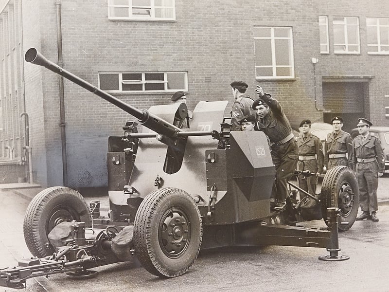 A gun team from the 444 Light AD Regiment prepares for action during a parade at Wolseley House, Fallings Park, in November 1966. The Wolverhampton Territorial unit was presented with a cup by Major General P. B. Gillett, GOC 43 Division (TA) and the West Midlands district, recognising them as the most efficient light air defence unit in the country. The Mayor of Wolverhampton, Mr F S Smith, was among those in attendance alongside the regiment's batteries, band, and corps of drums. Do you remember the Territorial Army parades at Wolseley House back in November 1966?