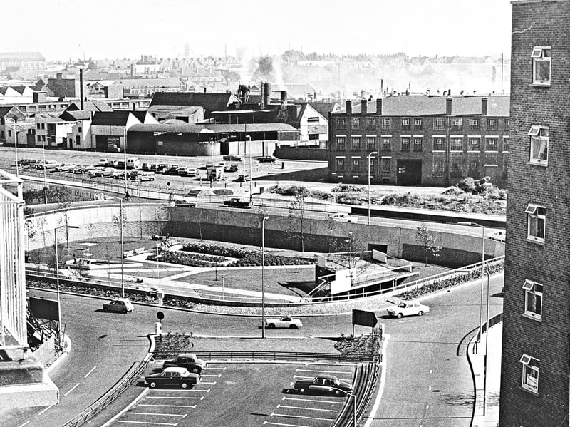 An elevated view taken from Graiseley Court Flats shows the newly laid out sunken gardens inside the Ring Road island in September 1966. The island features landscaped walkways, subways, and surrounding traffic lanes, contrasting the modern road scheme with the industrial townscape stretching out in the background. Do you remember looking out over this dramatic redesign of Wolverhampton's road network back in the 1960s?