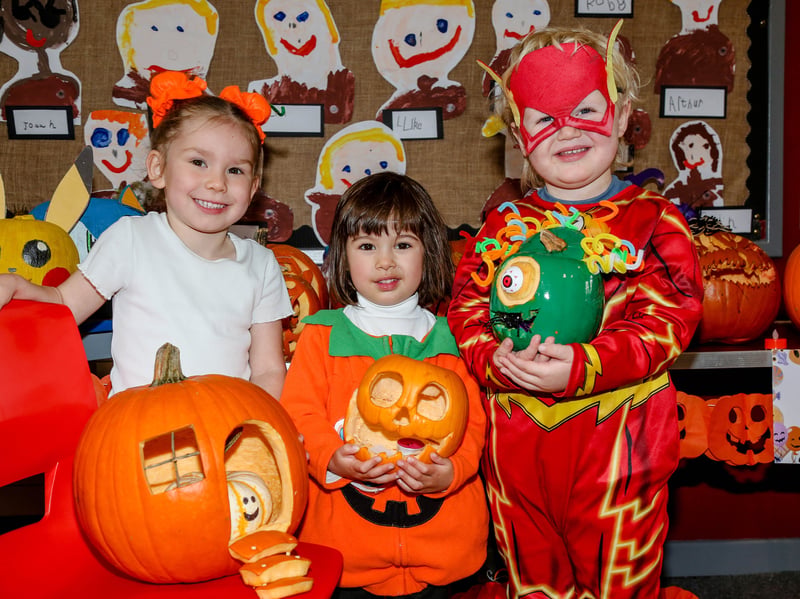 Ayda, Millie and Brody, from the Bush Nursery Unit, show off their pumpkins. AM264412