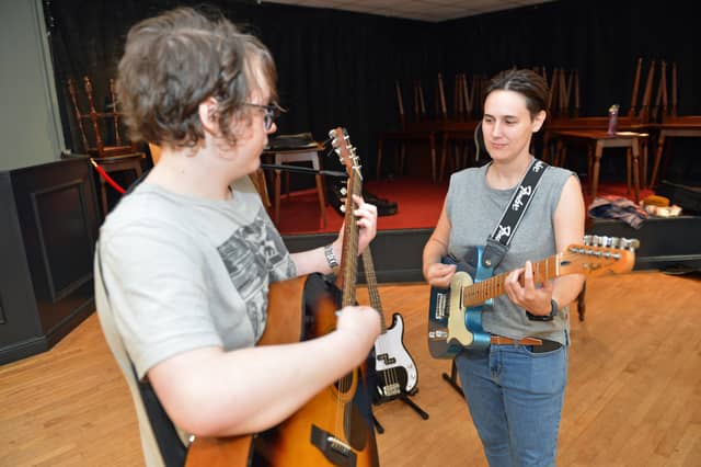 Music tutor Jess Allen teaching Ryan.