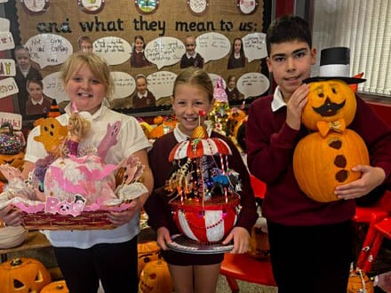 Maisie, Harper-Lee and Afonso with their fantastic entries in the Bush Primary School pumpkin carving competition. AM264416