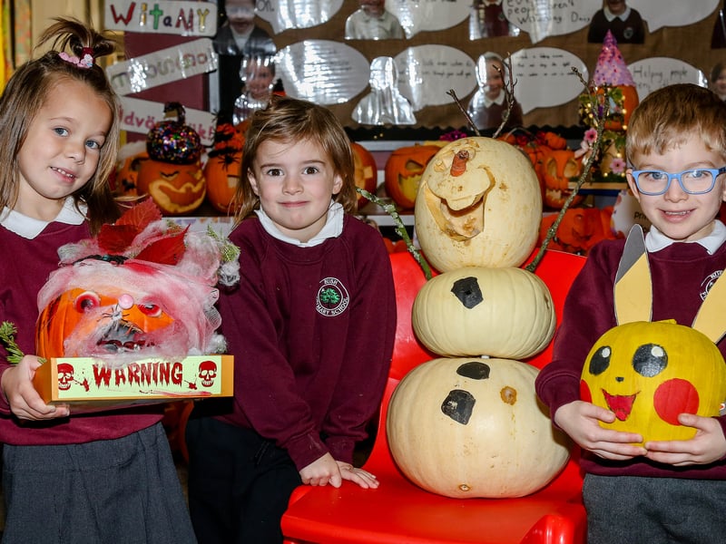 Bush PS P1 pupils, Linda, Eliza and Cooper, with their entries in the schools pumpkin carving competition. AM264409