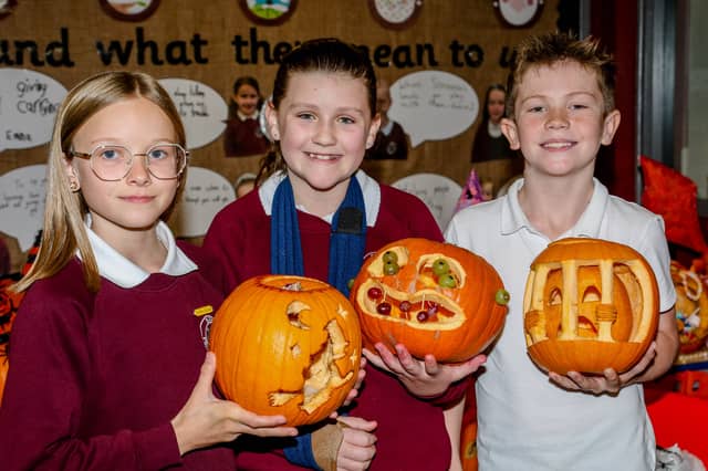 P7 pupils, Ellie, Mya and Hayden, who took part in the Bush PS pumpkin carving competition. AM264415