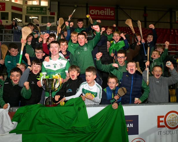 Shamrocks captain Aodhan Furlong holding the cup, surrounded by fans. Picture: Brendan Monaghan.