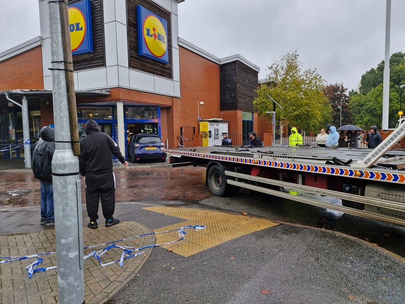 A large group had gathered outside to watch the car being recovered