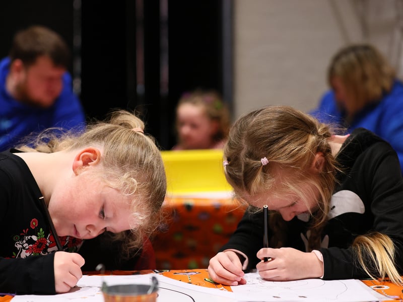 Friends Felicity, 6, and Willow, 6, right, concentrate on the their drawings. They were very keen to tell the photographer that they are “not twins”. Spooky fun and Portsmouth100 Lions at Fort NelsonPicture: Chris Moorhouse (241026-065)