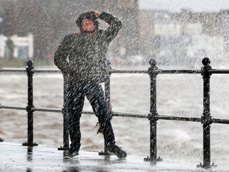 Waves crash over the promenade due to the affects of storm Boelo 