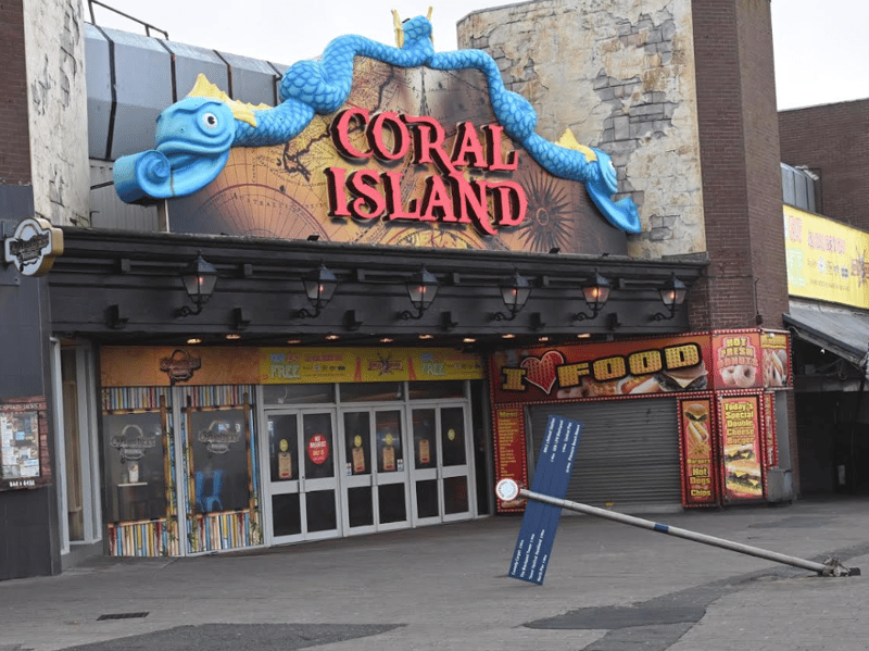 A signpost outside of Coral Island was bent by the winds.