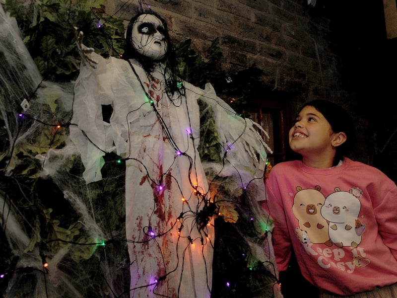 Zara Chambers, nine of Leeds gets a close look at one of the Halloween ghouls at Abbey House Museum 