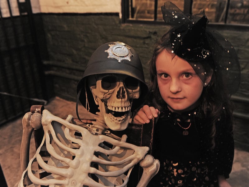 Amelia How , seven, of Leeds meets a policeman in the cell at Abbey House Museum