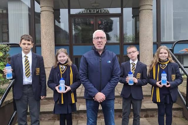 Omagh Academy pupils with their new reusable water bottles as part of NI Water’s Refillution campaign. SU4344CD26